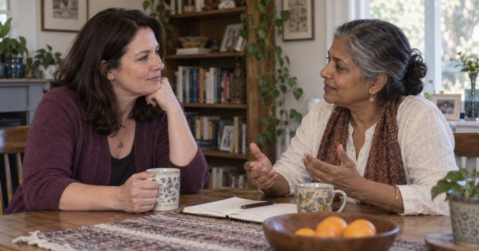 Two women sharing a supportive conversation beside a notebook at a home table.