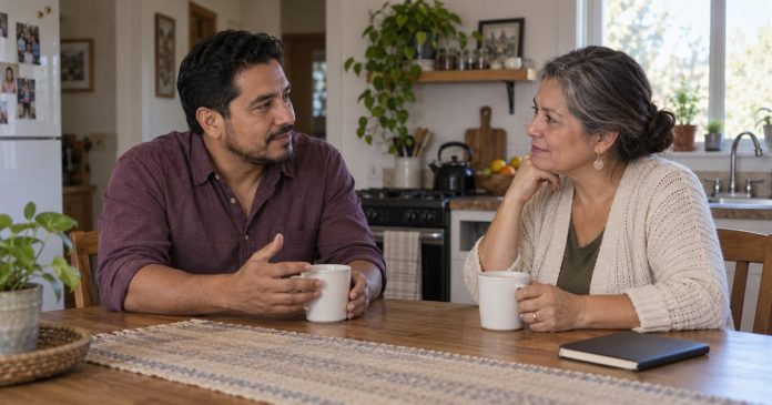 Spiritual Beliefs and Mental Health: Meaning Without Blame or Diagnosis Two adults having a respectful conversation at a modest home kitchen table.