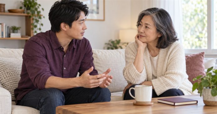 A calm supportive conversation at home Two adults in a calm, attentive conversation in a home living room.